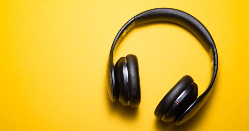 A wireless headset on yellow background.